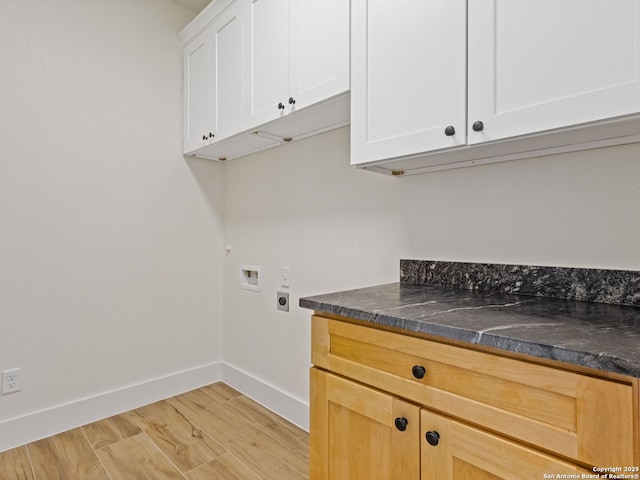 washroom with cabinets, hookup for a washing machine, light hardwood / wood-style flooring, and electric dryer hookup