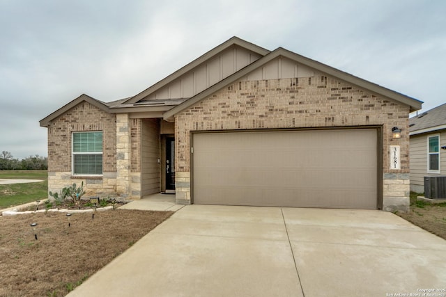 view of front of property with a garage and central AC