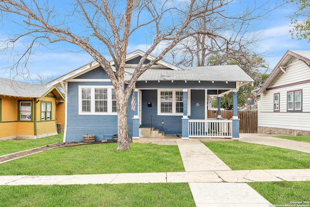 bungalow-style house featuring a front lawn and covered porch