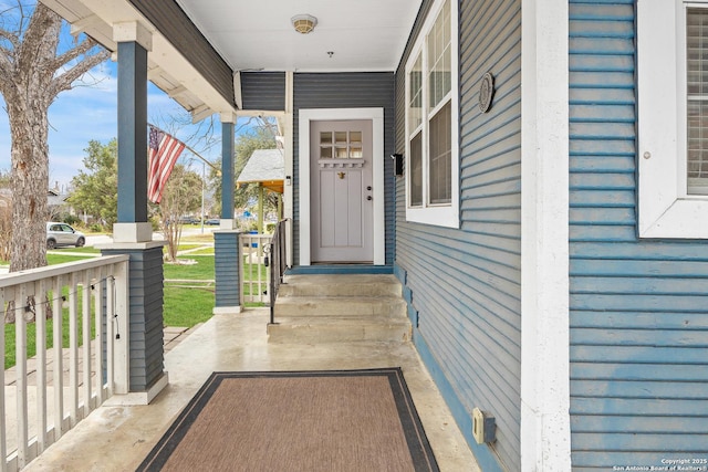 view of exterior entry with a porch