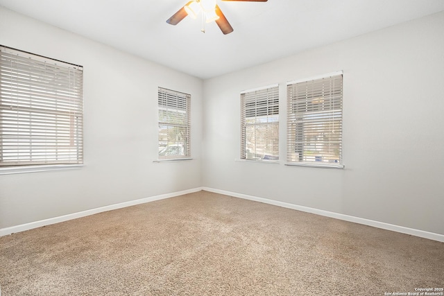 carpeted spare room with ceiling fan