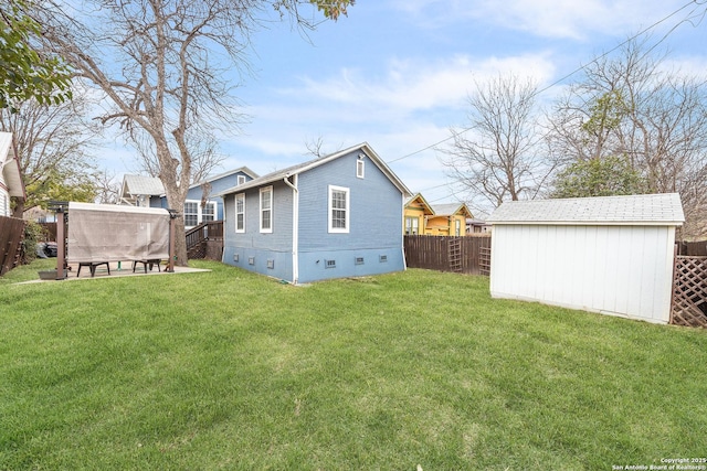 back of property with a yard and a storage unit