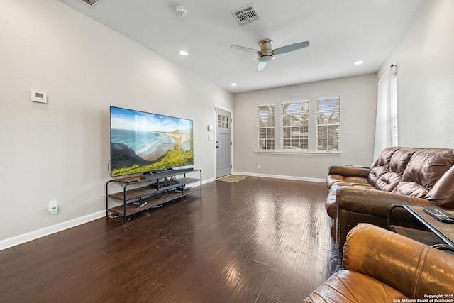 living room with dark hardwood / wood-style flooring and ceiling fan