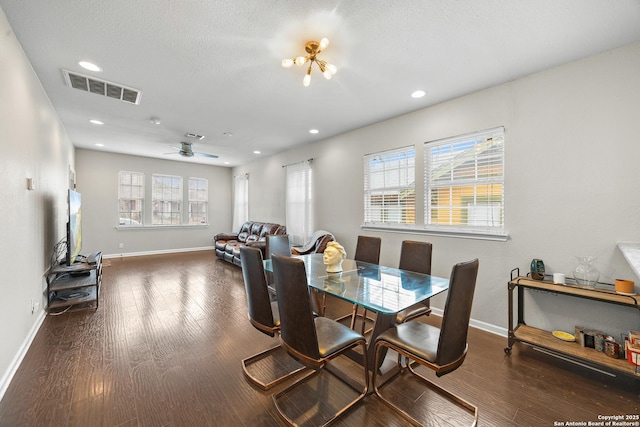 dining area featuring dark wood-type flooring, ceiling fan, a textured ceiling, and a wealth of natural light