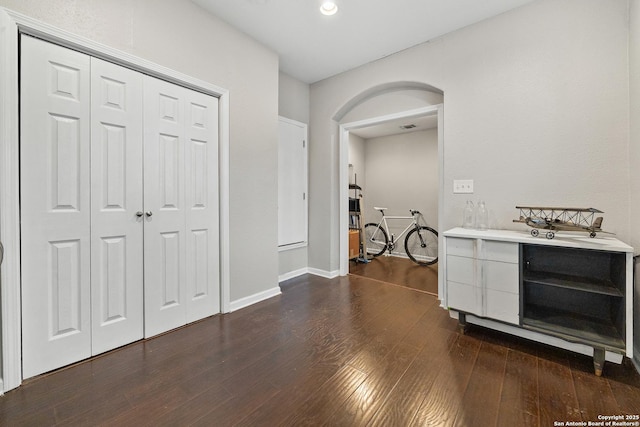 corridor featuring dark hardwood / wood-style flooring