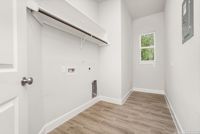 laundry area with electric dryer hookup, washer hookup, light hardwood / wood-style flooring, and electric panel