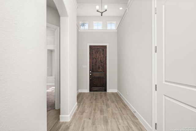 entrance foyer with a chandelier and light hardwood / wood-style floors