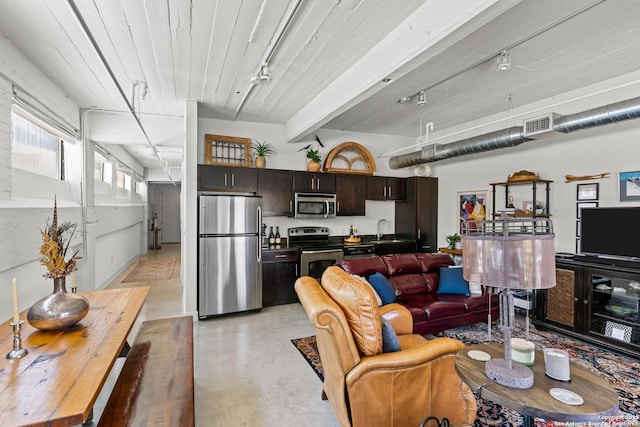 living room with sink and rail lighting