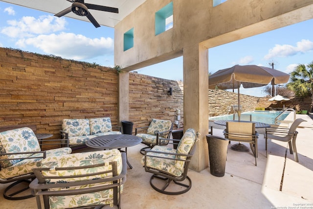 view of patio / terrace with ceiling fan, an outdoor hangout area, and a fenced in pool