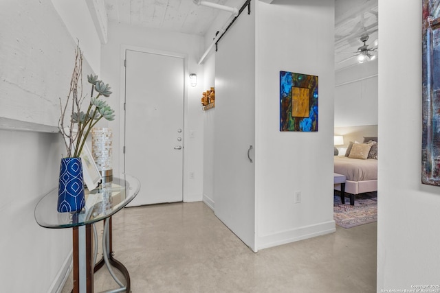 entrance foyer with a barn door and ceiling fan