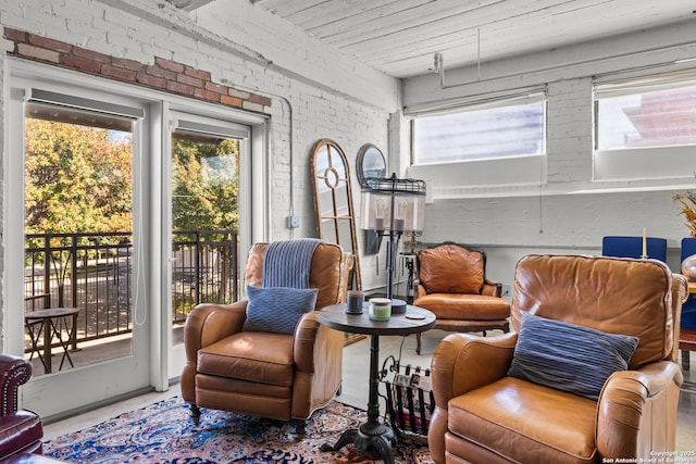 sitting room featuring brick wall