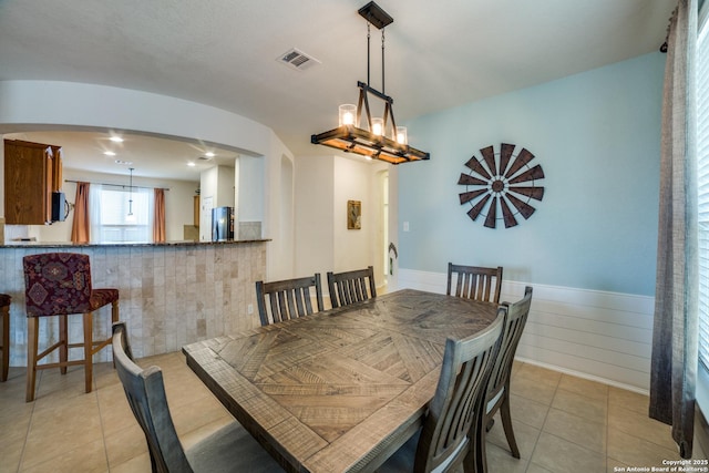 dining area with an inviting chandelier and light tile patterned floors