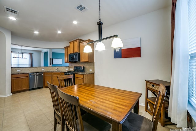 dining room featuring sink and light tile patterned floors