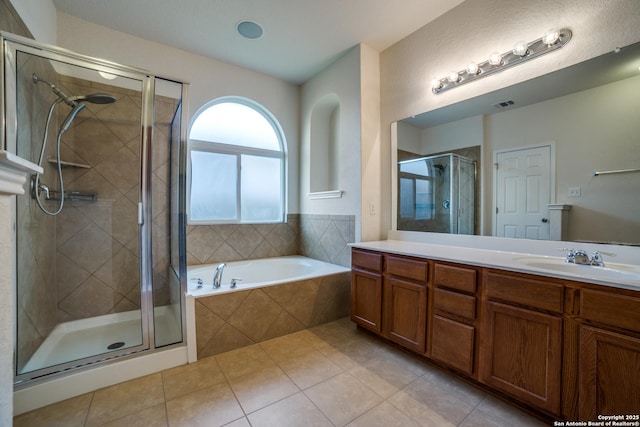 bathroom with independent shower and bath, vanity, and tile patterned floors