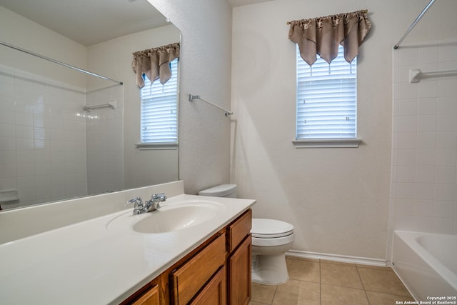 full bathroom featuring vanity, tiled shower / bath, tile patterned floors, and toilet