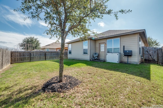 back of house featuring a yard