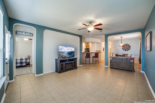 living room with light tile patterned floors and ceiling fan