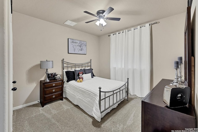 bedroom featuring light colored carpet and ceiling fan