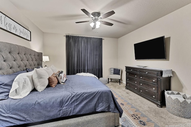 carpeted bedroom with a textured ceiling and ceiling fan