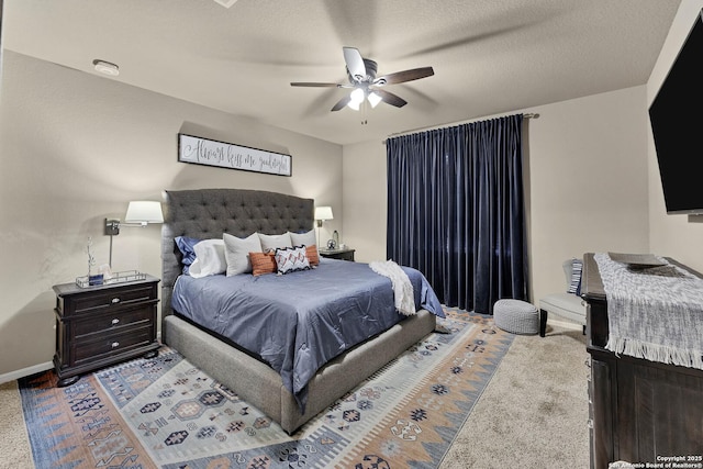 bedroom with ceiling fan and a textured ceiling