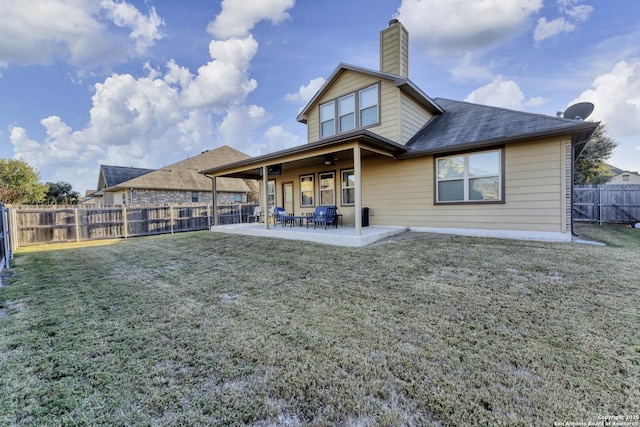 rear view of property with a patio area and a lawn