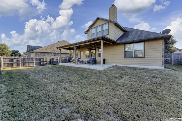 back of property featuring a yard and a patio