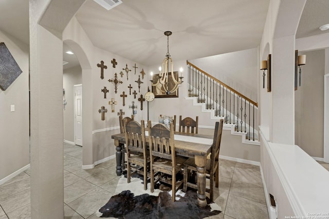 dining area featuring light tile patterned floors and a chandelier