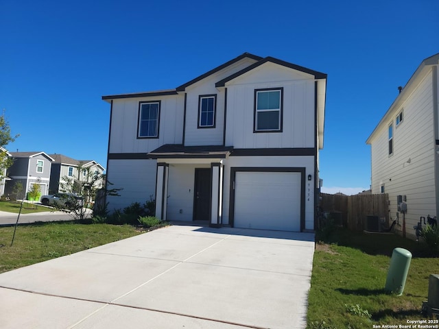 front facade featuring a garage, cooling unit, and a front yard