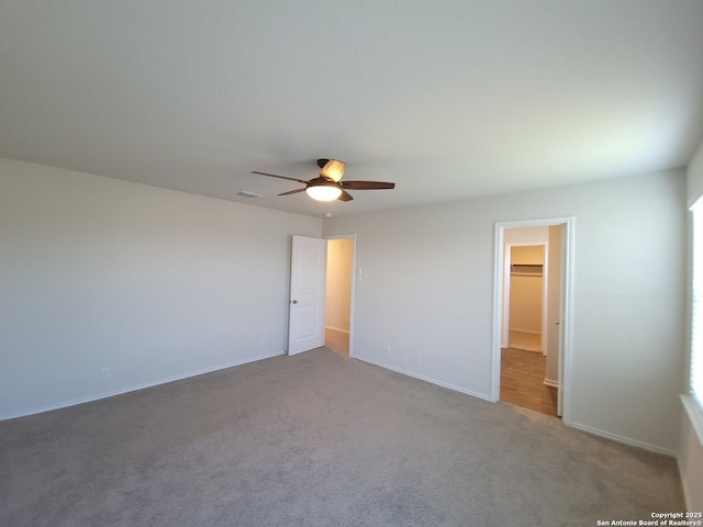 interior space with carpet floors and ceiling fan