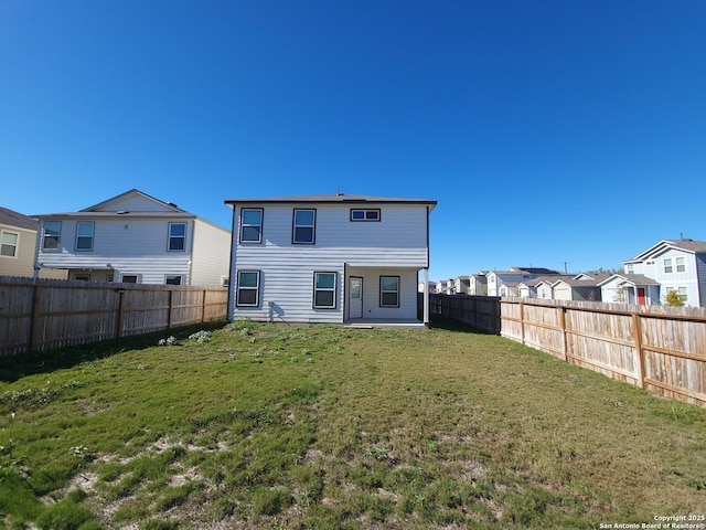 rear view of house with a yard