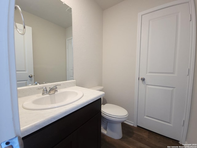 bathroom featuring hardwood / wood-style flooring, vanity, and toilet