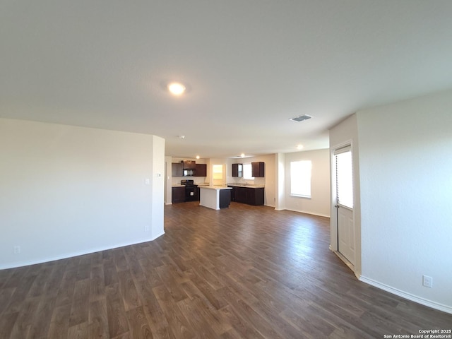 unfurnished living room featuring dark hardwood / wood-style floors