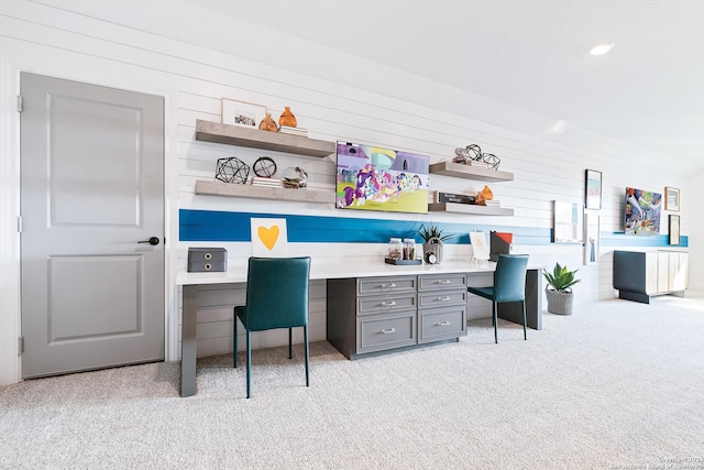 office space featuring light colored carpet and built in study area