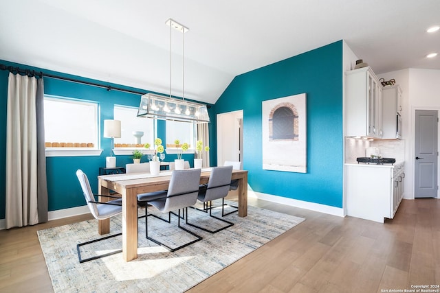 dining area featuring lofted ceiling, recessed lighting, light wood-type flooring, and baseboards