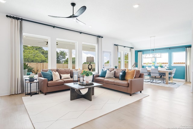 living area with light wood-style flooring and a ceiling fan