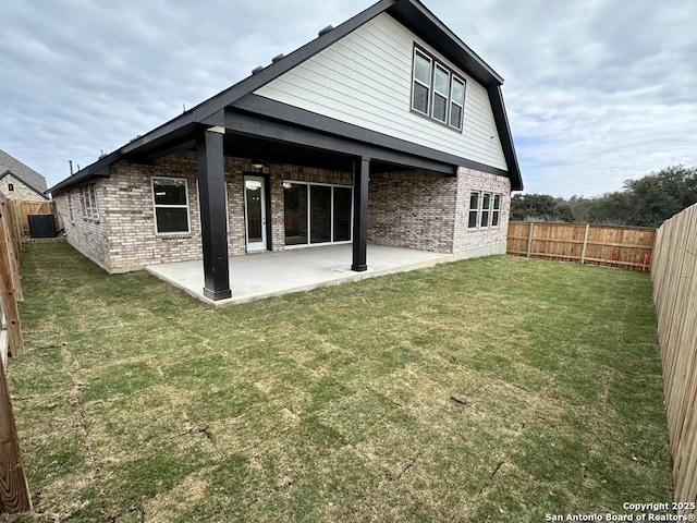 back of property with a patio area, brick siding, and a fenced backyard