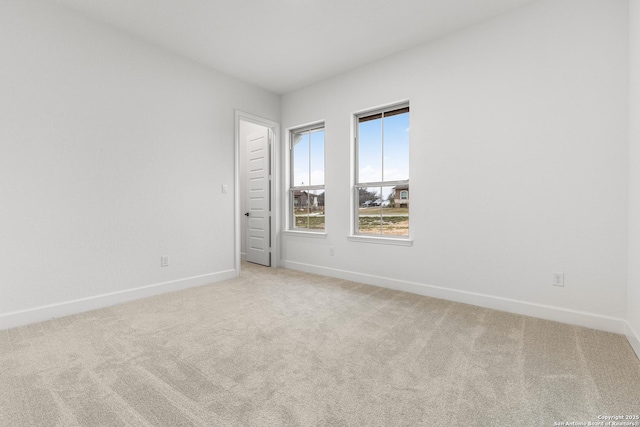 carpeted spare room with baseboards