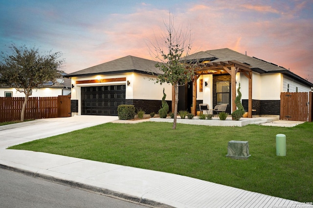 prairie-style house featuring a yard and a garage