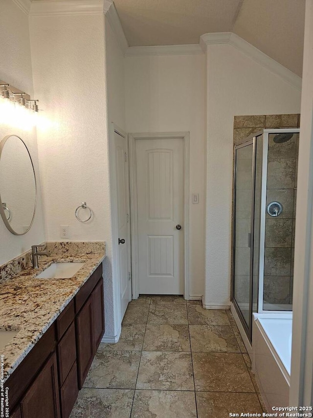 bathroom featuring vanity, crown molding, lofted ceiling, and separate shower and tub