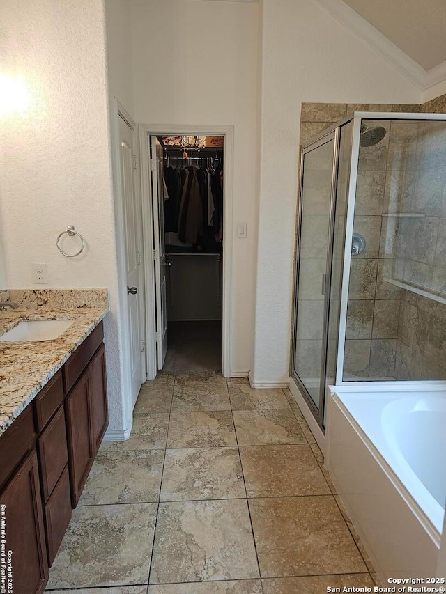 bathroom featuring independent shower and bath, vaulted ceiling, and vanity