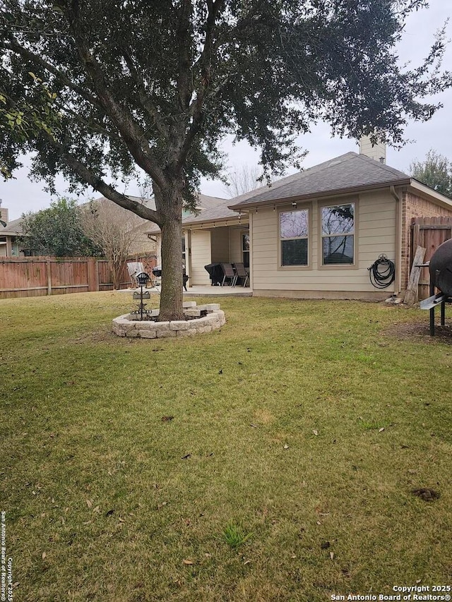 rear view of house featuring a lawn