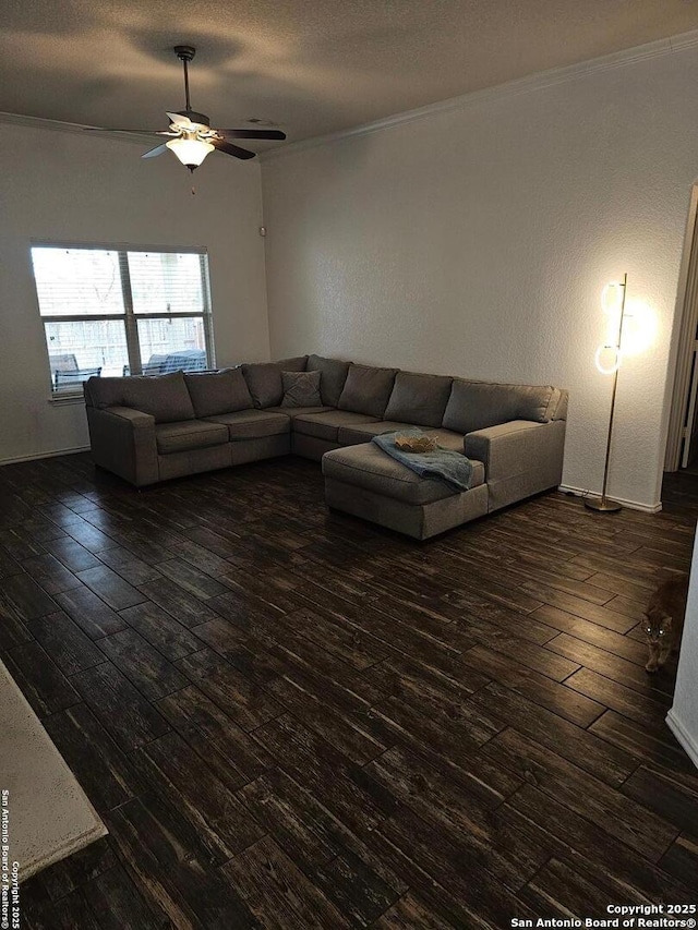 unfurnished living room featuring dark wood-type flooring, ceiling fan, ornamental molding, and a textured ceiling