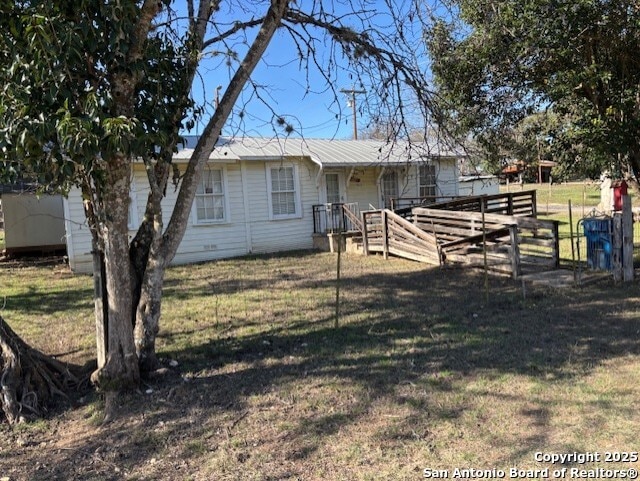 rear view of property with a lawn