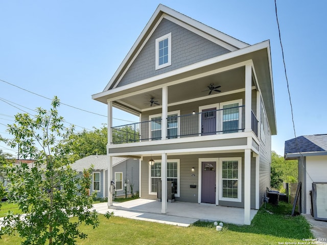 back of house featuring ceiling fan, a yard, a patio, and a balcony