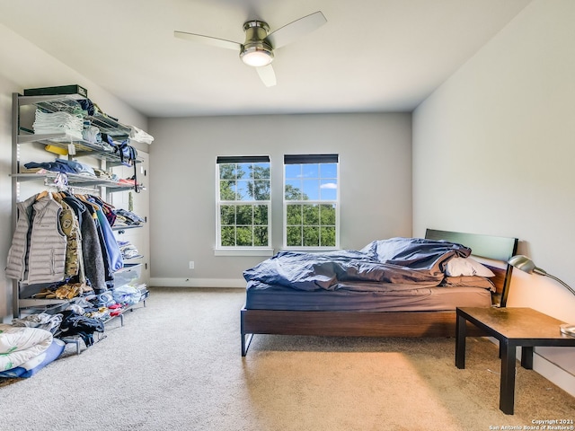 bedroom featuring ceiling fan and light carpet