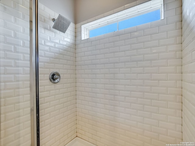 bathroom with tiled shower