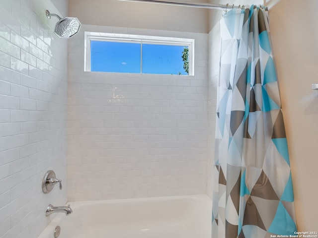 bathroom with shower / tub combo with curtain