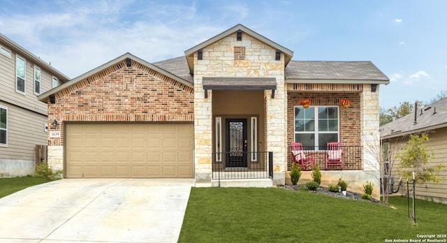 view of front of house featuring a garage, a front yard, and covered porch