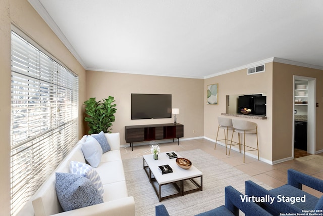 living room featuring light tile patterned floors and crown molding