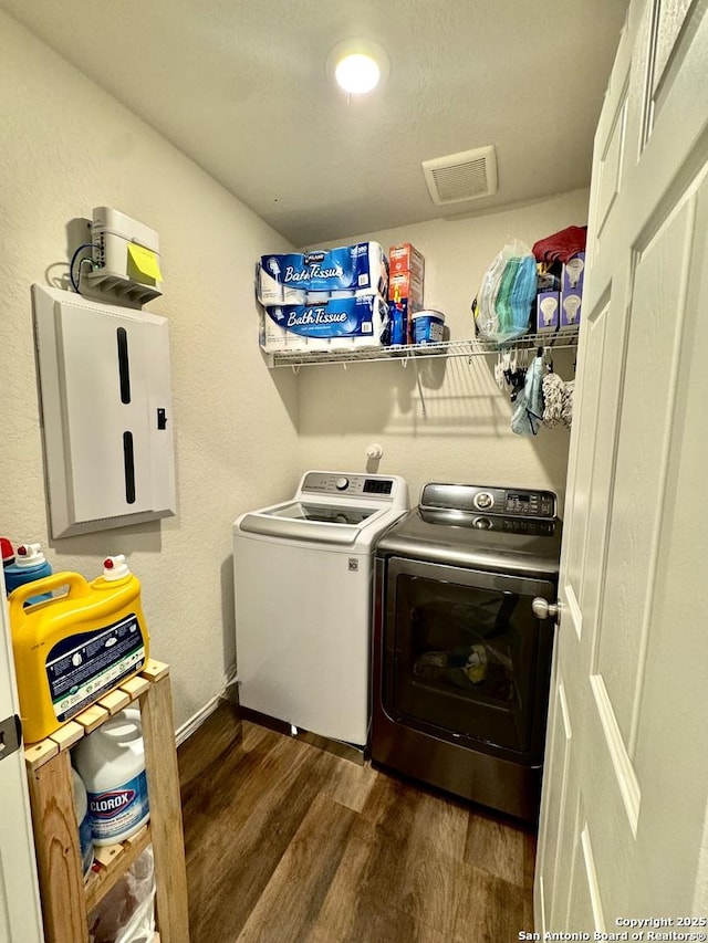 laundry area with dark wood-type flooring and washing machine and dryer